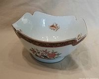 Front view showing exterior armorial and floral panel, scalloped rim