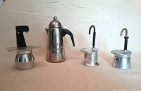 All four espresso pots lined up to show variety and scale