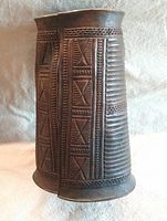 front view of brass wrist guard showing relief design