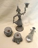 Group view of dancer figure, two drums and sitar container