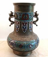 Full view of bronze vase showing shape, enamel decoration and handles