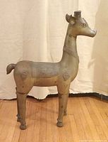 Full view of bronze deer standing