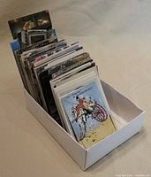Box containing large stack of postcards and cards