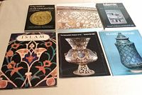 All six books laid out showing front covers