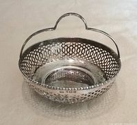 Oblique view showing pierced sides, handle, interior