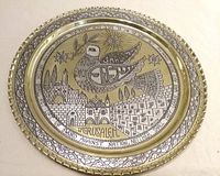 Full view of round brass tray showing entire design and scalloped rim