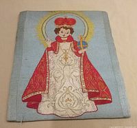 Full view of embroidered Salvator Mundi panel showing entire design and mounting