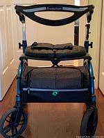 Front view of Evolution zerO rollator walker showing seat, pouch and wheels