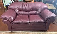Front view of burgundy faux leather loveseat