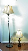 Floor and table lamps side by side illustrating size difference, base details, and cords