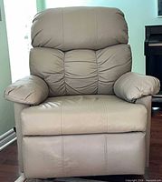Front view of beige faux leather recliner armchair