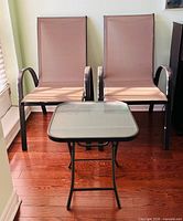 Full view of two sling chairs and side table