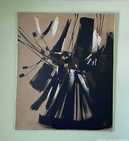 Full view of framed abstract painting on wall