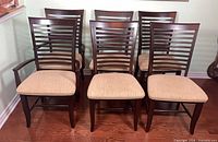Front view of all six slat-back chairs showing arm and side versions
