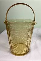 Front view of etched glass ice bucket with handle raised
