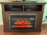 Front view showing fireplace insert and media shelf