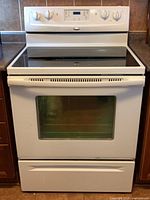 Front view of white Whirlpool glass top electric range