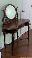 Front angled view of Bombay wood vanity with oval mirror attached