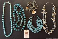 Group shot of all five turquoise-tone necklaces