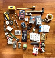 Overhead view of entire assortment showing tools, hardware, adhesives, electrical items