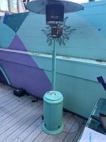 Full view of Fire Sense turquoise patio heater on deck