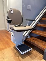 Overall view of installed stair lift chair and rail