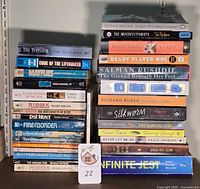 Both stacks of 30 paperbacks, showing spine titles
