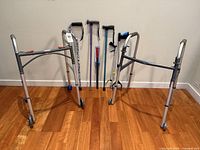 Overall lot: two walkers, canes, grabbers, shoehorn