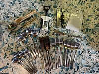 All flatware and kitchen tools laid out on surface