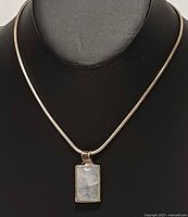 Full view of sterling silver necklace with moonstone pendant on display bust