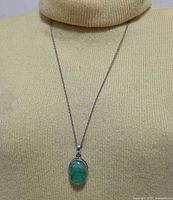 Full view of sterling silver chain with green prasiolite pendant on mannequin