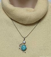 Necklace on mannequin showing length and pendant