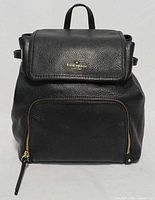 Front view showing overall design, flap, logo, and front zip pocket