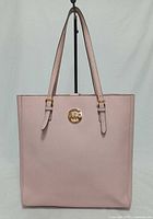 Front view of pink Michael Kors tote showing logo and straps