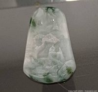 Front view of carved jadeite pendant