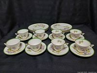 Full set of eight cups, saucers and plates displayed