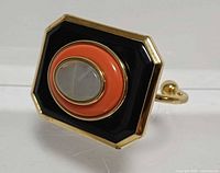 Front angled view of bracelet showing enamel colours and centre stone