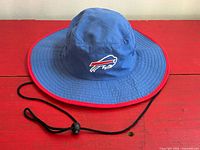 Hat top view showing wide brim, chin cord, team logo