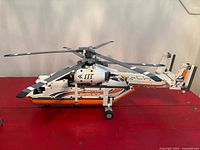 Right-side profile of assembled helicopter showing fuselage, landing gear and tail boom