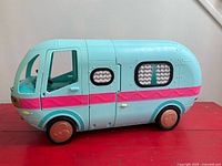 Closed teal/aqua camper showing exterior details