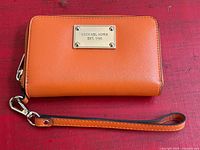 Front view showing logo plaque, strap and hardware