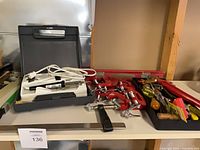 Overview of soldering kit, clamps, hand tools on shelf