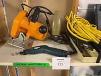 Overall view of circular saw, jigsaw, rotary tool, extension cord, wrench tray