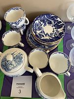 Overall view showing teapot, creamer, cups, plates and bowls