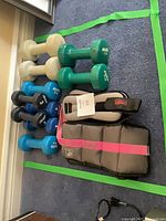Overview of weighted vest, ankle weights and dumbbells within taped area