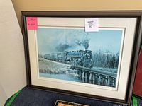 Front view of framed blue-toned steam locomotive print on bridge