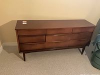 Front view of walnut nine-drawer sideboard
