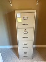 Full front view of beige four-drawer filing cabinet
