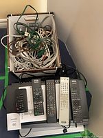Overall lot: players stacked, remotes on top, cables box