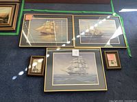 Group shot of three large framed color ship prints and two small sepia prints